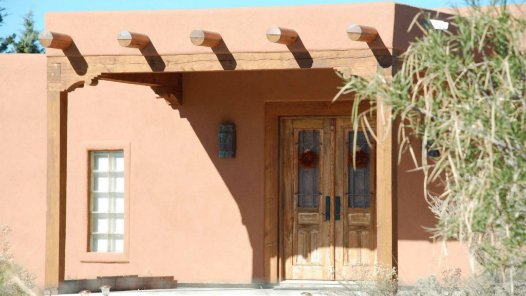 Front door of brown stucco house