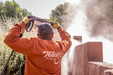 Tesuque Stucco contractor pressure washing old stucco off of fence